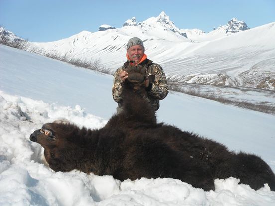 This man posed proudly with the bear he shot while it was hibernating. The poor animal didn’t stand a chance.