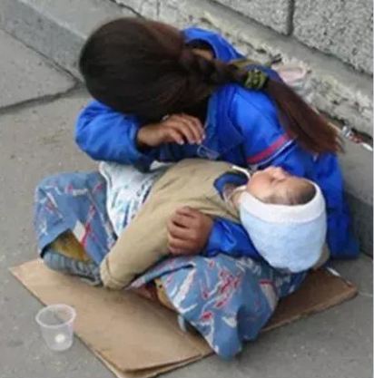 Why is the child in hands of the beggar always sleeping?